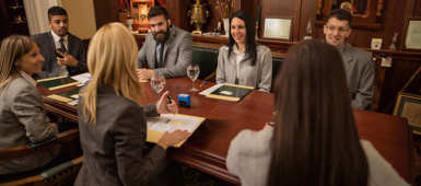 Group of legal professionals discussing Lexcel accreditation in their office